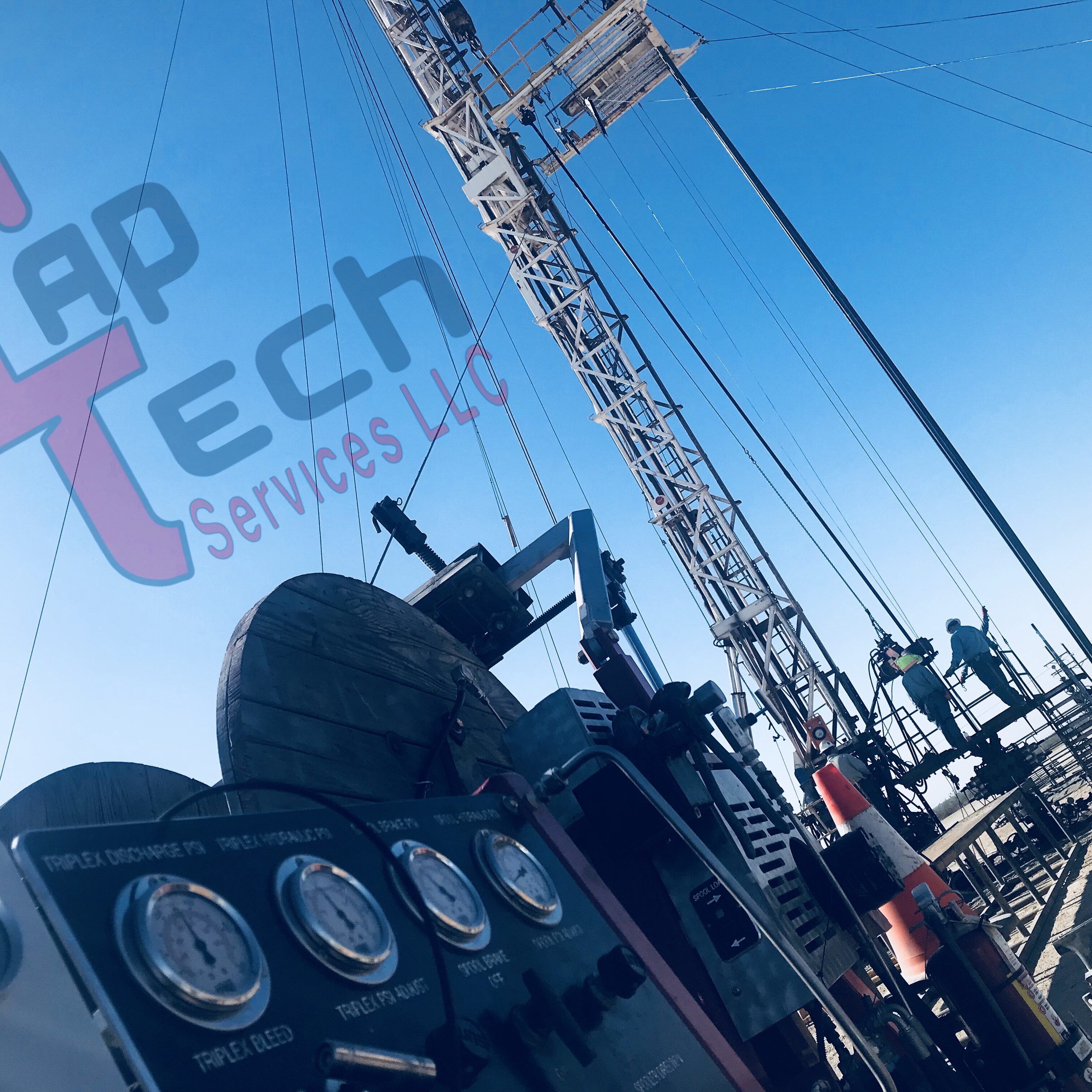 Oil drilling rig with clear blue sky and gauges in foreground.